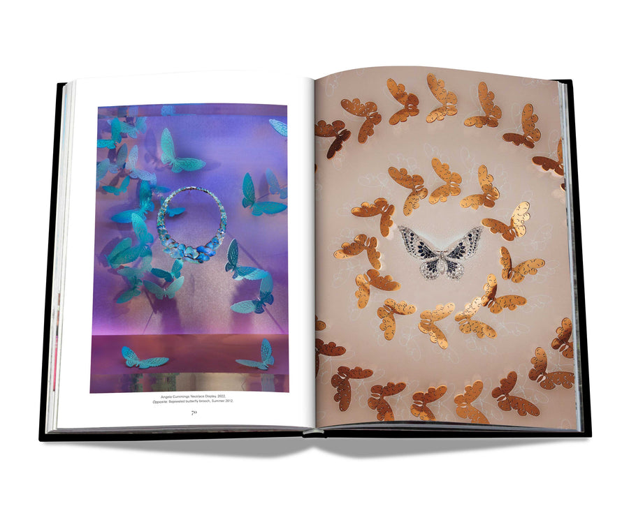 Assouline Windows at Tiffany & Co Icon Edition coffee table book page with Blue & Gold sparkling butterflies jewellery designs on white back ground available at Spacio India for luxury home decor accessories collection of Jewellery Coffee Table Books.