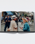 Open book showing a photograph of two women on a city street.