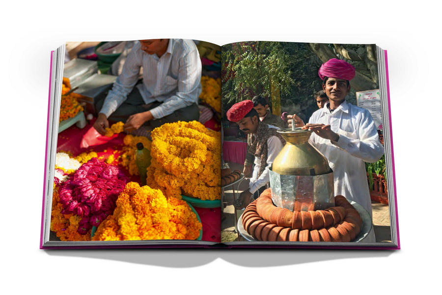 Assouline Jaipur Splendor coffee table book displaying photo of Kulhad Tea Seller & Marigold flowers at Jaipur on a white back ground available at Spacio India for luxury home decor accessories collection of Travel Coffee Table Books.