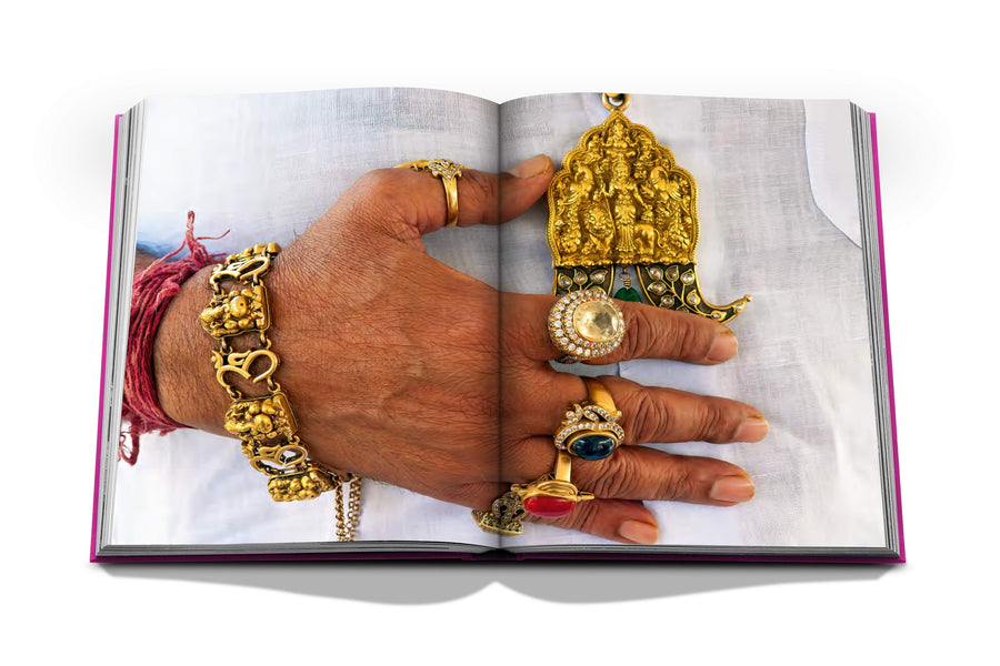 Assouline Jaipur Splendor coffee table book displaying photo of Rajasthani royal man wearing gold jewelleries as a symbol of culture on a white back ground available at Spacio India for luxury home decor accessories collection of Travel Coffee Table Books.