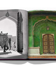 Assouline Jaipur Splendor coffee table book displaying photo of The City palace Green door & Elephants at the gates of Amber Palace, on the outskirts of Jaipur, 1940 on a white back ground available at Spacio India for luxury home decor accessories collection of Travel Coffee Table Books.