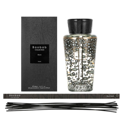 A Baobab Black Pearls Diffuser DIF500PB, filled with a fragrant ginger scent, is placed next to a box.