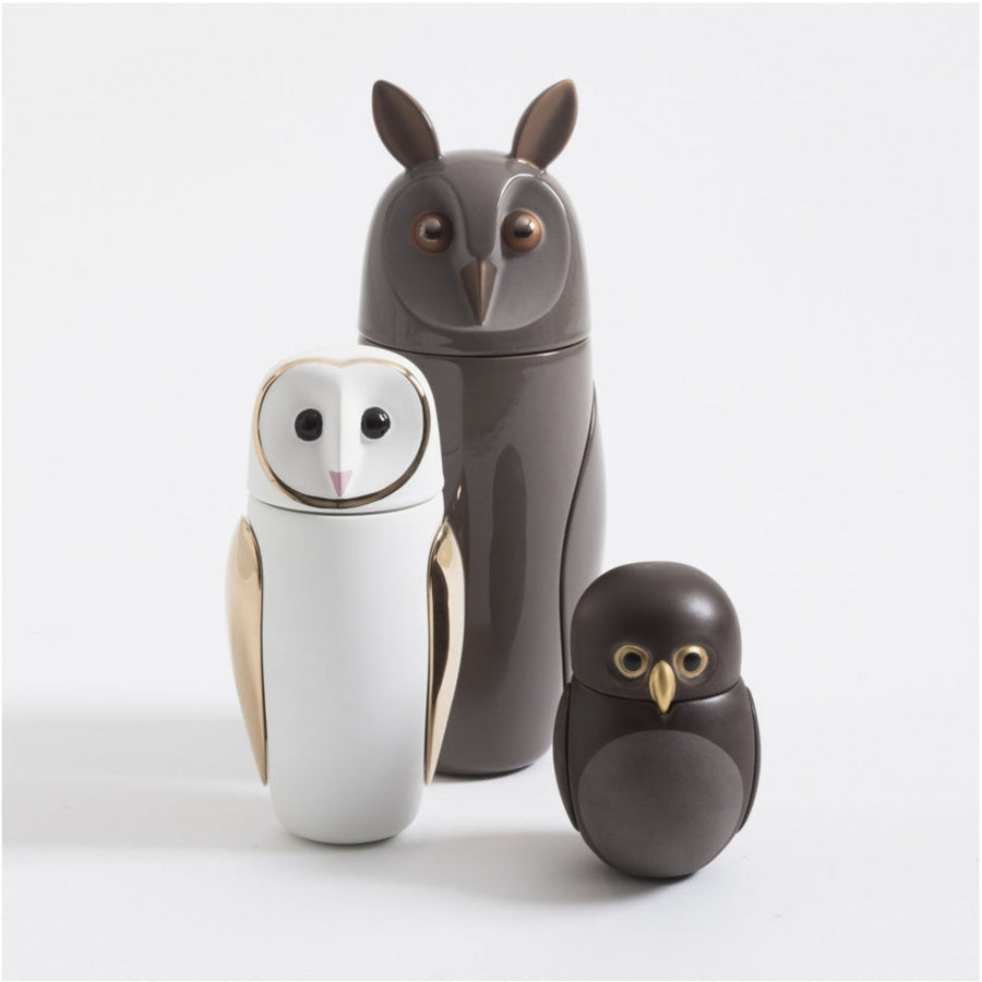 Three Bosa Barns The Owls, including a Barn Owl sculpture, sitting next to each other on a white surface.