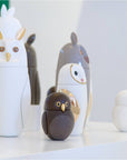 A Bosa Barns The Owl collection of owl shaped vases, including a Barn Owl sculpture, adorns a table.