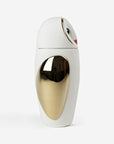 A white and gold Bosa Barns The Owl bottle from Manolo Bossi's Owls collection, placed on a white surface.