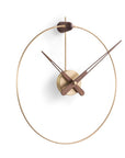 A Nomon Micro Anda G MCANG wall clock with a circular shape hanging on a wall.