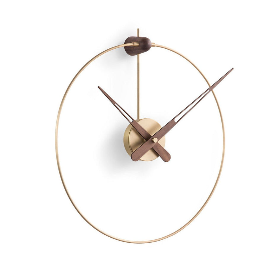 A Nomon Micro Anda G MCANG wall clock with a circular shape hanging on a wall.