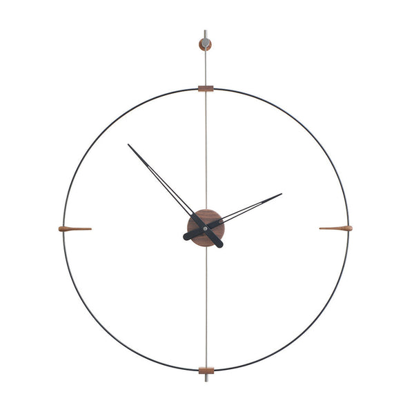 A Clock Nomon Mini Bilbao MBI with a sleek circular design hanging on a wall.