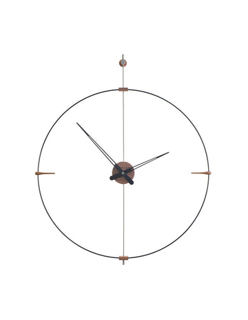 A Clock Nomon Mini Bilbao MBI with a sleek circular design hanging on a wall.