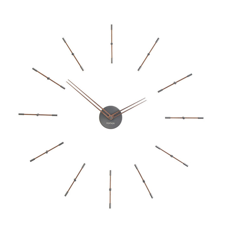 An elegant Nomon clock with metal rods on a white background.