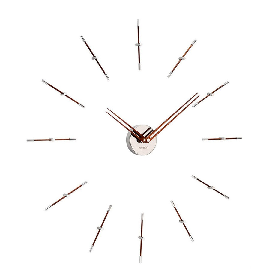 A Nomon minimalist wall clock with a circular pattern on a white background.