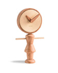 A Nomon Nena Oak and Brass NENARG wooden clock featuring a charming wooden figure on it.