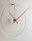 A Nomon minimalist wall clock with a red clock face.