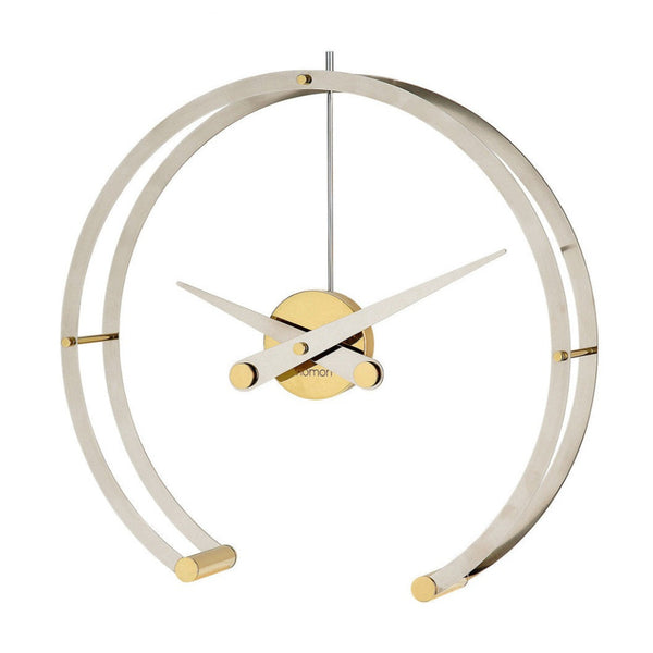 A sleek gold and brass Clock Nomon Omega G OMG with a professional style, featuring a circular shape.