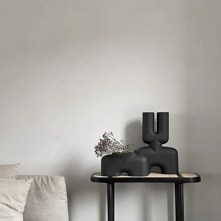 A 101Cph Cobra Double Medio Coffee 211037 vase in the brand of 101 Copenhagen sits on a table in a quirky living room interior setting.