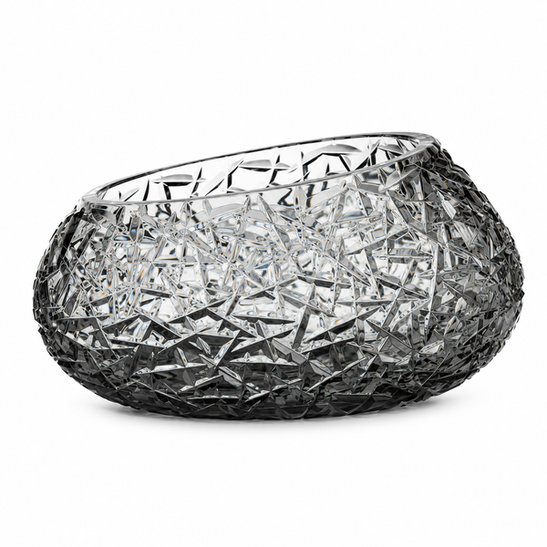 A grey crystal bowl with an intricate, faceted starburst pattern throughout, set against a plain white background.