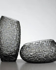 A pair of matching grey colour crystal vase and bowl from Duccio Di Segna available at Spacio in India. 
