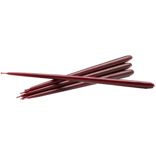 Six dark red taper candles crossed over each other on a plain white background from Ester & Erik available at Spacio in India.