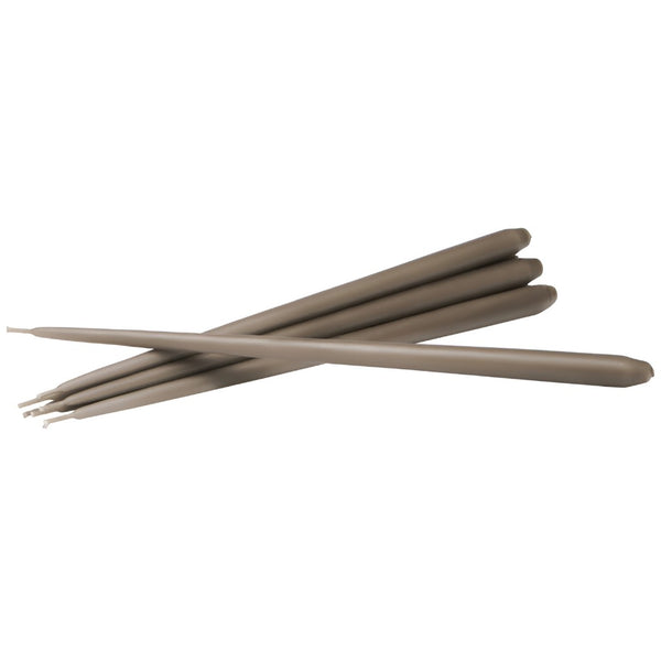 Six long, slim taupe-brown sticks, likely wax taper candles, arranged in a crossed diagonal pattern on a solid white background by Ester & Erik, available at Spacio in India