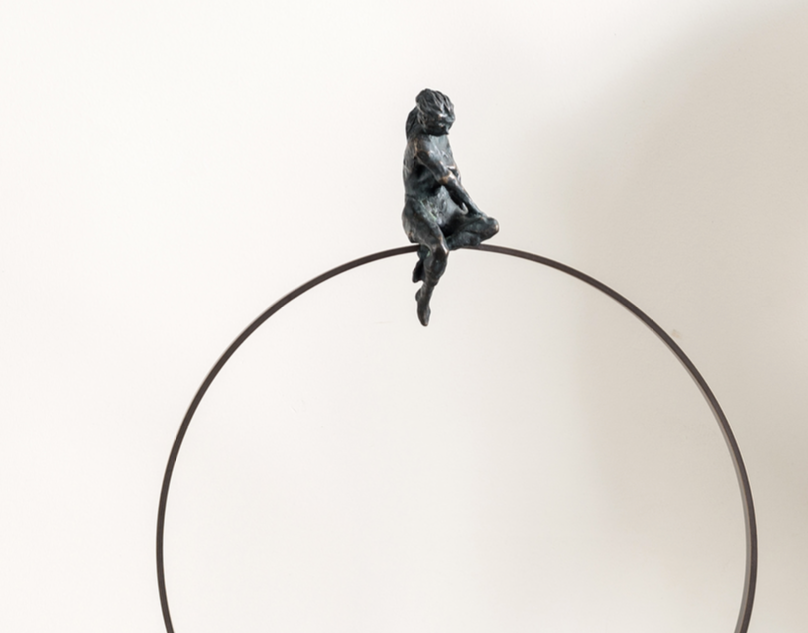 A Gardeco Limited Edition Gardeco Bronze Sculpture Lost in Thoughts, created using the lost wax method, of a monkey sitting on a hoop.