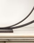 A Gardeco Bronze Sculpture Lost in Thoughts (Limited Edition) on top of a marble mantel.