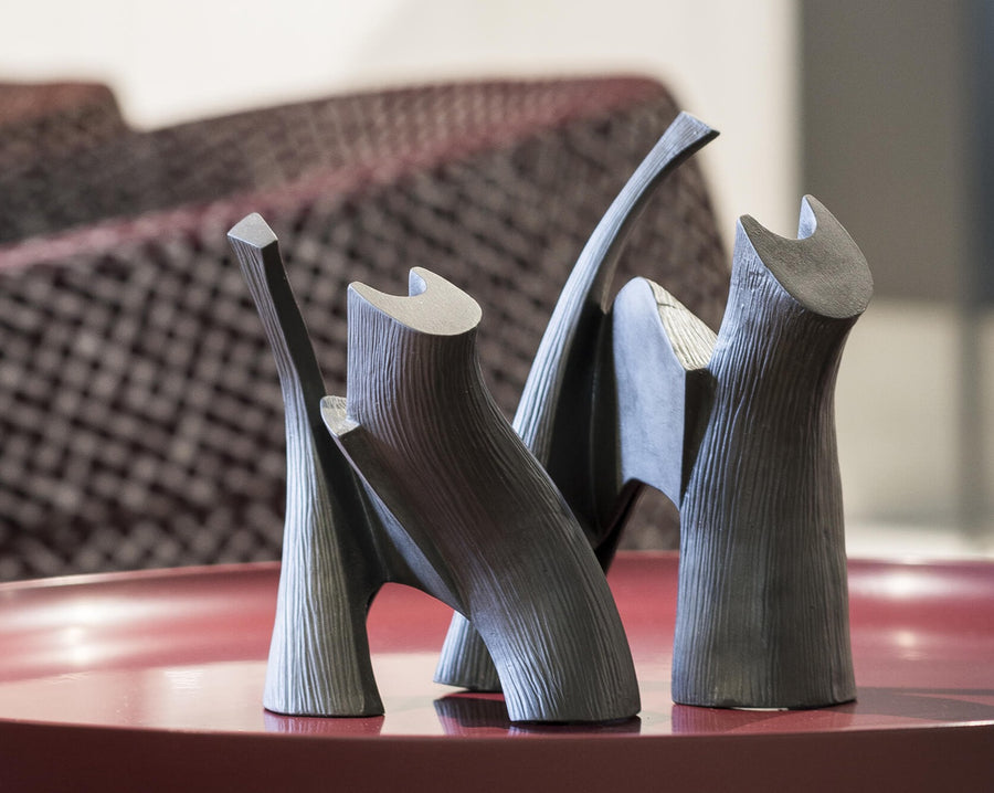 Two Gardeco Ceramic Sculpture Darius Black cat sculptures sit on a red table.