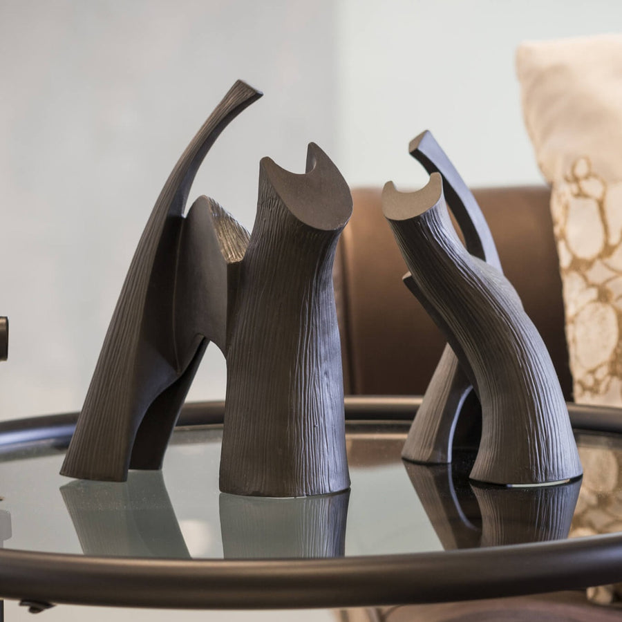 Two Gardeco Ceramic Sculpture Darius Black cat figurines sit on a table in a living room.