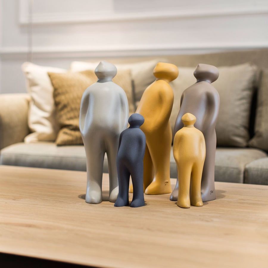 A group of Gardeco Ceramic Sculpture Visitor Small Caqui Cor21 with a caqui finish on a table in a living room, created by a Belgian sculptor.