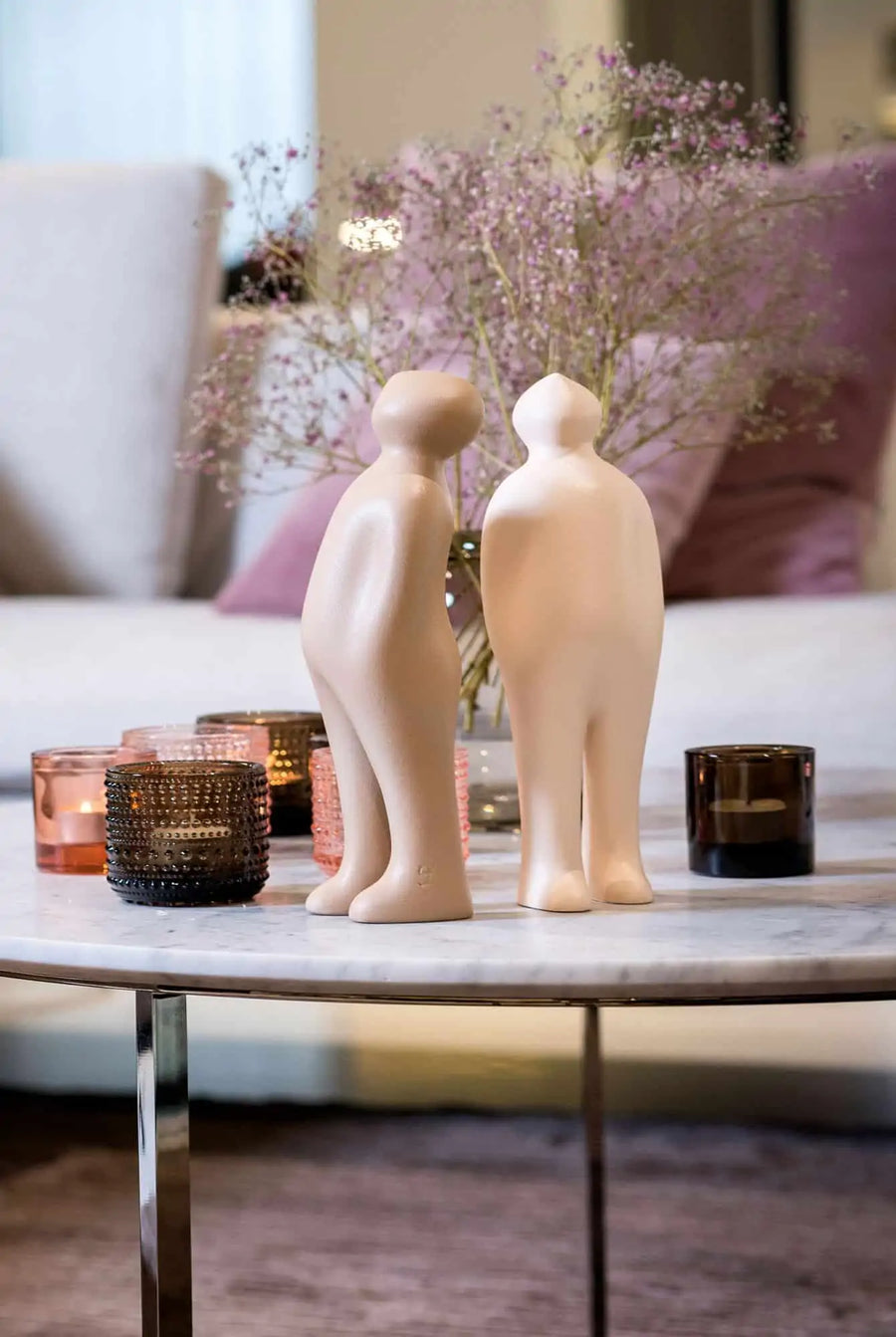 Two Gardeco Ceramic Sculpture Visitor Small Dune Cor47 figurines on a coffee table, showcasing exquisite craftsmanship.