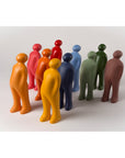 A group of small figurines with different colored finishes, including green, black, and Gardeco Ceramic Sculpture Visitor Small Green Alfafa Black Cor37.