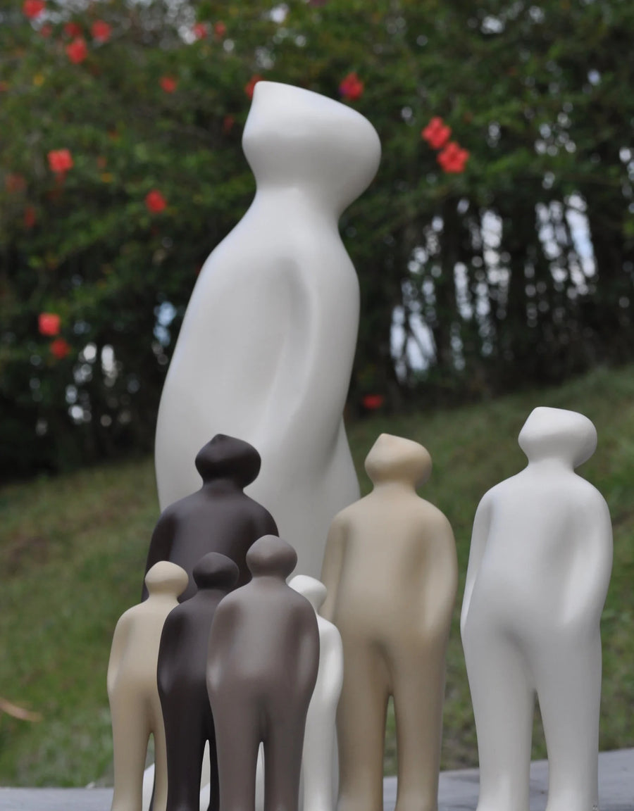 A collection of Gardeco Ceramic Sculpture Visitor Small Sand Cor02 figurines, created by a Belgian sculptor.