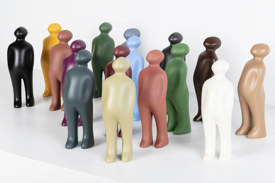 A group of Gardeco Ceramic Sculpture Visitor Small Taupe Cor27 figurines on a white surface, created by a Belgian sculptor.