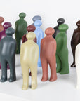 A group of Gardeco Ceramic Sculpture Visitor Small Verde Cor52 figurines in different colors on a white surface.