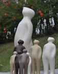 A collection of Gardeco Ceramic Sculpture Visitor Small Taupe Cor27 objects standing next to each other, created by a Belgian sculptor.