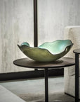 In the interior space of a room, a Gardeco artist has placed a delicate Gardeco Glass Bowl Mapa 30 Verde on a table.