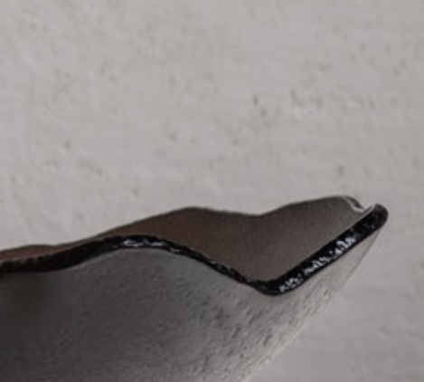 A close up of a Gardeco Glass Bowl Mini Mapa Corten in an interior space.