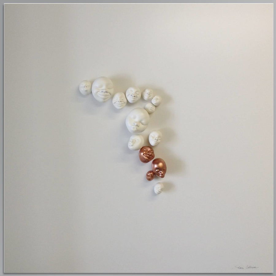 A collection of Gardeco Wall Sculpture Happy Faces on a white surface.