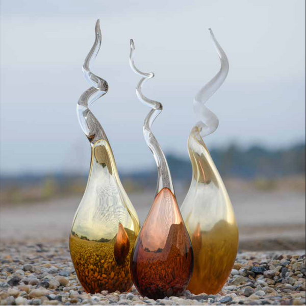 Limited Edition Glasremis Sculpture Her Moods pristine white glass sculptures sitting on the ground.