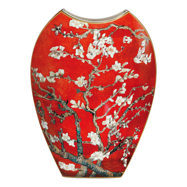 A glossy red ceramic vase featuring a detailed floral print of white blossoms and brown branches, with a gold-toned rim, shown against a plain white background. Artwork of Vincent van Gogh by Goebel, available at Spacio in India. 