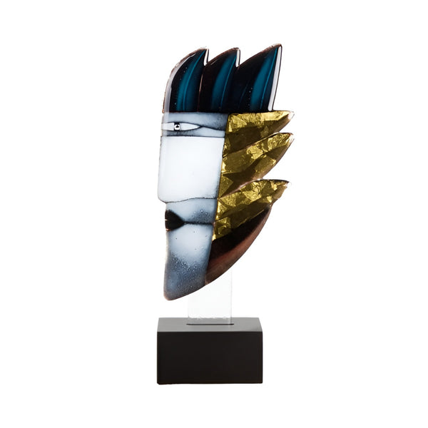 A modern abstract sculptural mask on a clear acrylic stand with a black rectangular base. The mask features a white face with a black eye detail, dark blue leaf-like shapes on top, and textured metallic gold and brown layered shapes on the side.