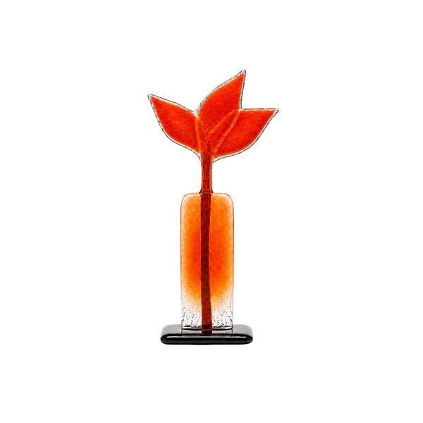 A modern sculpture with a rectangular body, a textured orange-red stem, and three stylized leaf-like forms at the top, resting on a small black base against a white background.