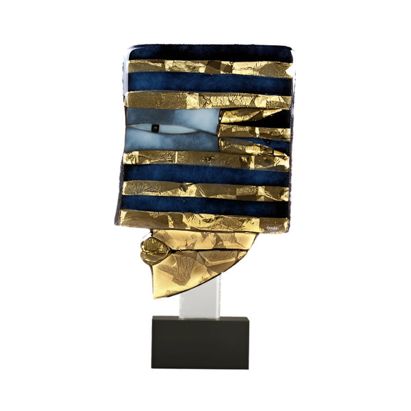 Decorative glass sculpture in gold, blue and black finish on a white background