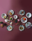 Qing Alhambra Rose stack set laying on dining table with other cutlery & kitchen accessories with food ingredients available at Spacio India for Luxury Home Decor Collection of Tableware Accessories