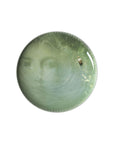 A plate from Ibride Yuan Noir Narcisse Stack table set containing a print human face & a boat available at Spacio India for home decor collection of Tableware Accessories