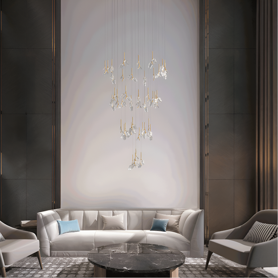 Modern living room with sofa, chairs and the Bloome chandelier from Italamp, available at Spacio retail stores in India. 