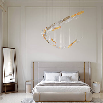 Modern bedroom with a bed, mirror, and decorative fluid art glass lighting installation from Italamp's Kaleido collection, available at Spacio in India. 