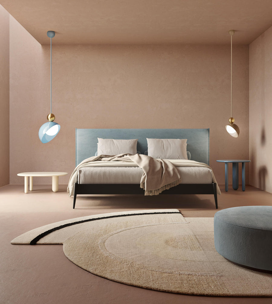 A versatile and vibrant lighting design from the Aurora Collection by Italamp featuring brushed gold accents, white glass diffuser, and retro-inspired finishes. A pair of pendant lights on the sides of a modern luxury bedroom