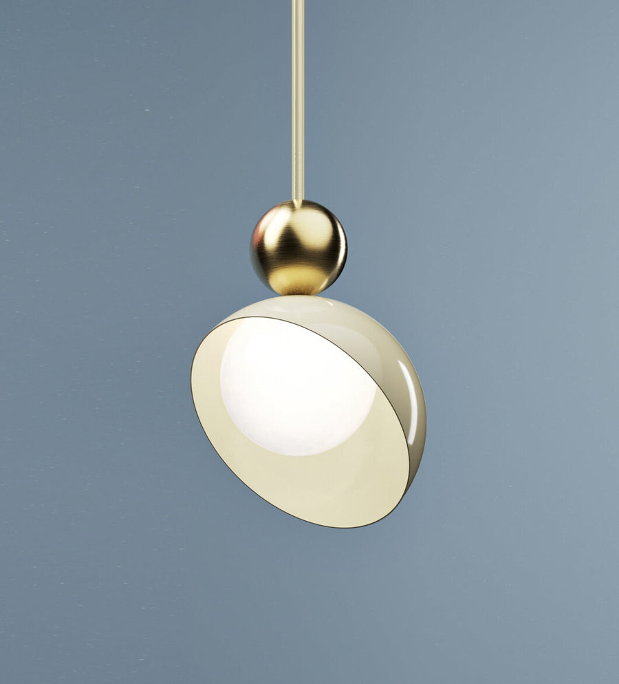 A versatile and vibrant lighting design from the Aurora Collection by Italamp featuring brushed gold accents, white glass diffuser, and retro-inspired finishes. A closeup view of the ivory finish pendant lamp in smaller size