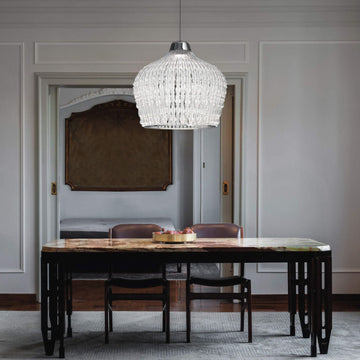 The Italamp Crowns Chandelier, crafted in Italy, features an Imperial Elegance dining room with a chandelier hanging over a table. This stunning piece from Italamp is designed to Illuminate the entire space, creating a luxurious atmosphere.