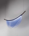 An Italamp Dali blue thermoformed glass pendant light hanging from a metal rod.